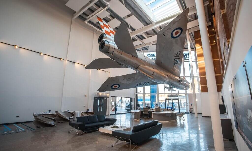 An interior shot of Vanguard's Bristol branch showcasing the fully restored English Electric Lightning fighter jet plane hanging in the reception.