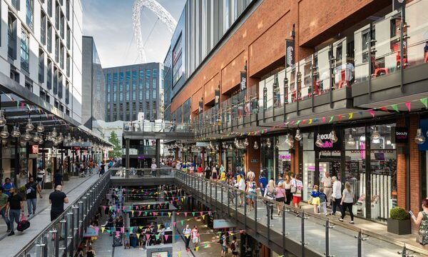 A photo showing the London Designer Outlet in Wembley, with the Wembley Stadium in the background.