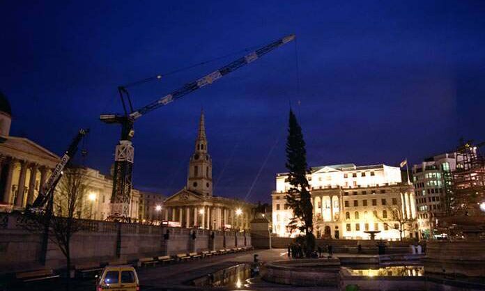 An old photo showing a Vanguard crane installing the Christmas tree at Trafalgar Square.