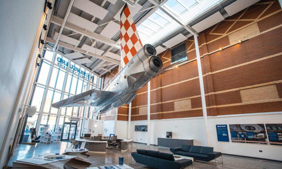 A photo showing the reception of the Vanguard Self Storage branch in Bristol, featuring a fully restored fighter jet hanging from the ceiling.