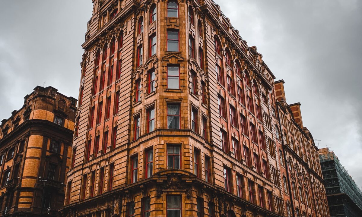 A photo showing the exterior of a building near a busy road.