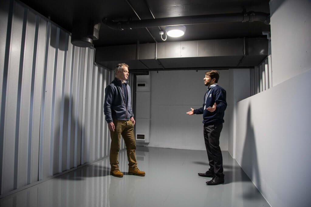 A photo of a Vanguard employee showing a customer the inside of one of our self-storage units.