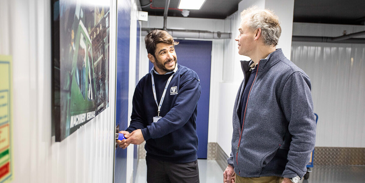A photo showing a Vanguard employee showing a customer around one of Vanguard's self storage branches.