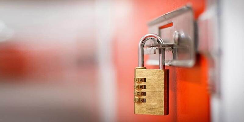 A close-up photo of a padlock closing a self-storage unit.