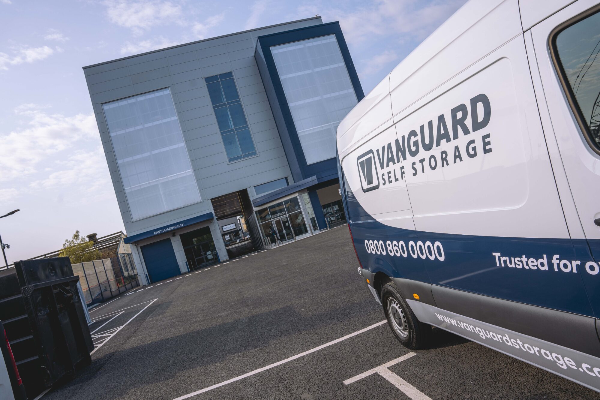 A photo showing the exterior of the Vanguard Self Storage branch in Staples Corner, with the Vanguard van parked on the right.