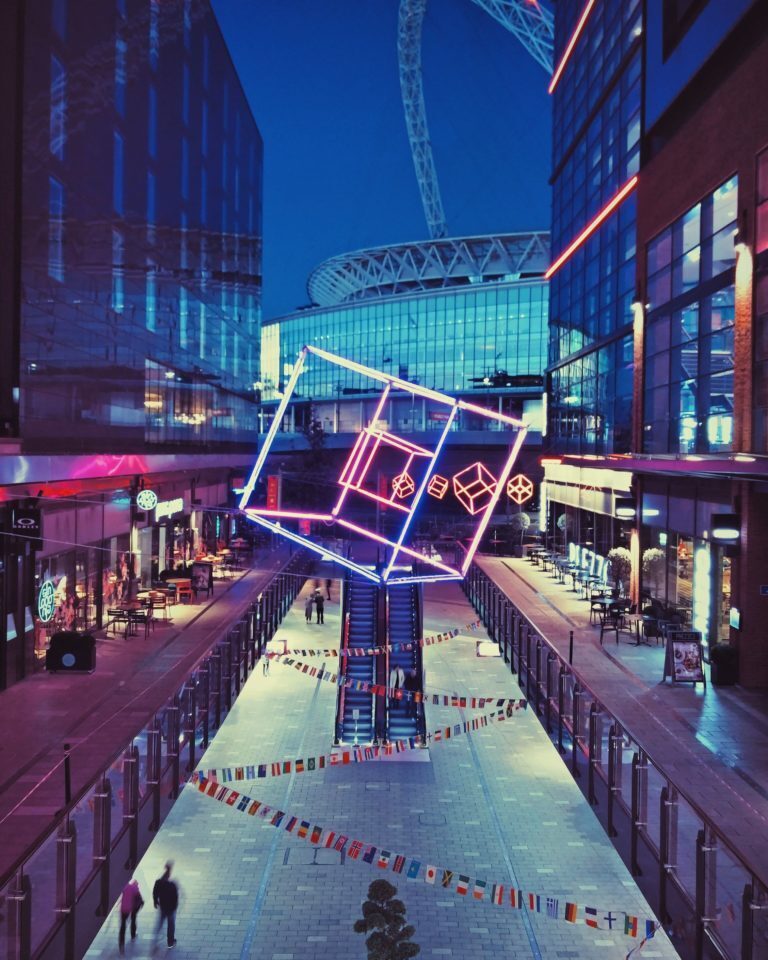 A photo of the London Designer Outlet in Wembley with the Wembley Stadium in the background.