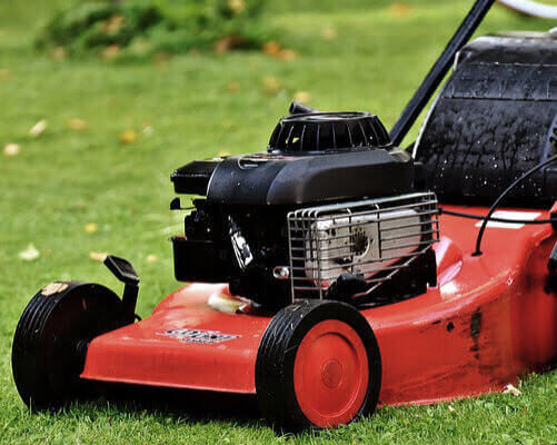 A photo showing a lawn mower on green grass.