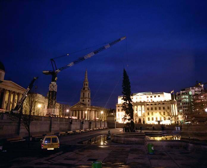 An old photo showing a Vanguard crane installing the Christmas tree at Trafalgar Square.